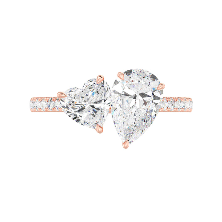 18K Rose Gold Toi et Moi Engagement Ring featuring a 1.50ct Pear-Cut and 1.00ct Heart-Shaped Lab-Grown Diamond, set in a classic prong setting with a pavé diamond band. A timeless and elegant symbol of love in warm rose gold