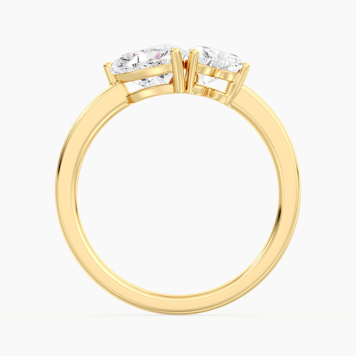 18K Yellow Gold Toi et Moi Double Heart Diamond Engagement Ring with a 1.00ct and 0.50ct heart-cut lab-grown diamond in a classic prong setting, symbolizing love and unity