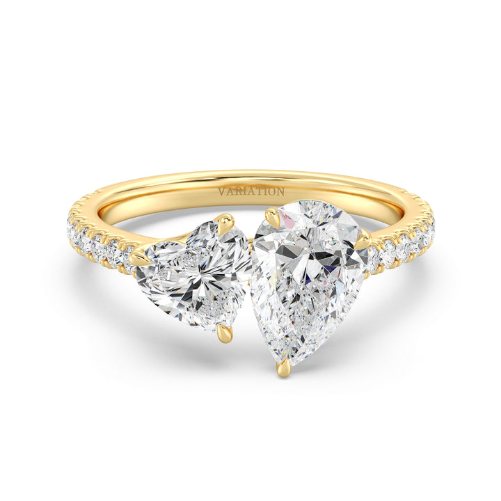 18K Yellow Gold Toi et Moi Engagement Ring with a 1.50ct Pear-Cut and 1.00ct Heart-Shaped Lab-Grown Diamond, accented by a pavé band with 20 round-cut diamonds (0.36ct total). A romantic two-stone design symbolizing love and unity