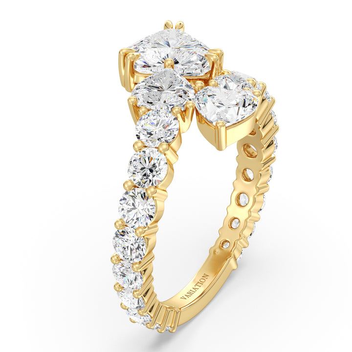 A breathtaking Three-Stone 'Toi et Moi' Heart-Shaped Lab-Grown Diamond Cluster Ring in 18K Yellow Gold, featuring two 0.50ct EF/VS heart-cut lab-grown diamonds, a 1.00ct EF/VS heart-cut lab-grown diamond, and 18 round lab-grown diamonds, totaling 4.17ct. The classic prong setting enhances brilliance, while the warm yellow gold band adds a timeless touch.