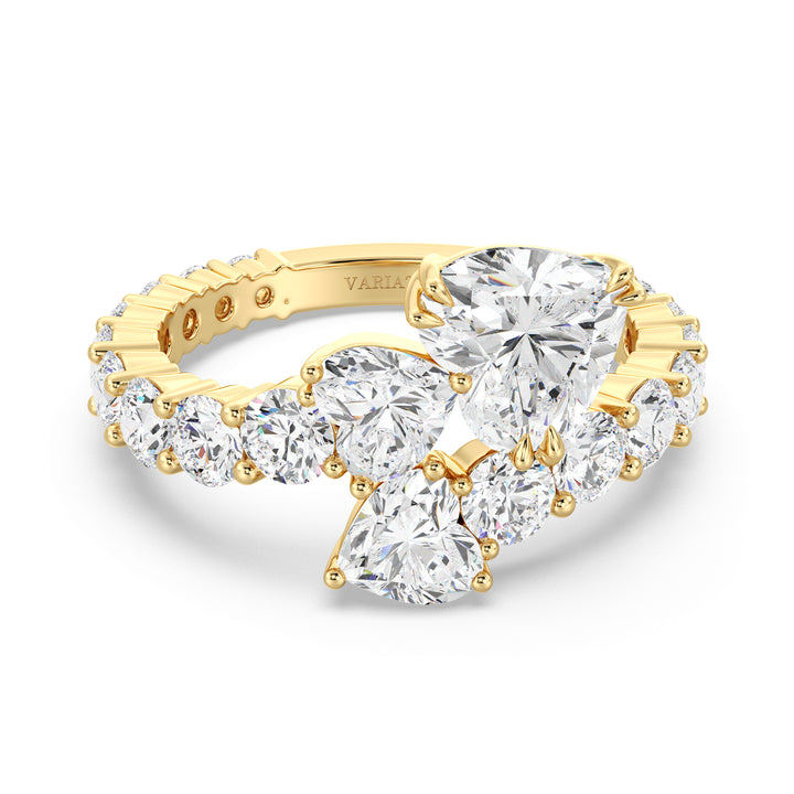 A breathtaking Three-Stone 'Toi et Moi' Heart-Shaped Lab-Grown Diamond Cluster Ring in 18K Yellow Gold, featuring two 0.50ct EF/VS heart-cut lab-grown diamonds, a 1.00ct EF/VS heart-cut lab-grown diamond, and 18 round lab-grown diamonds, totaling 4.17ct. The classic prong setting enhances brilliance, while the warm yellow gold band adds a timeless touch.