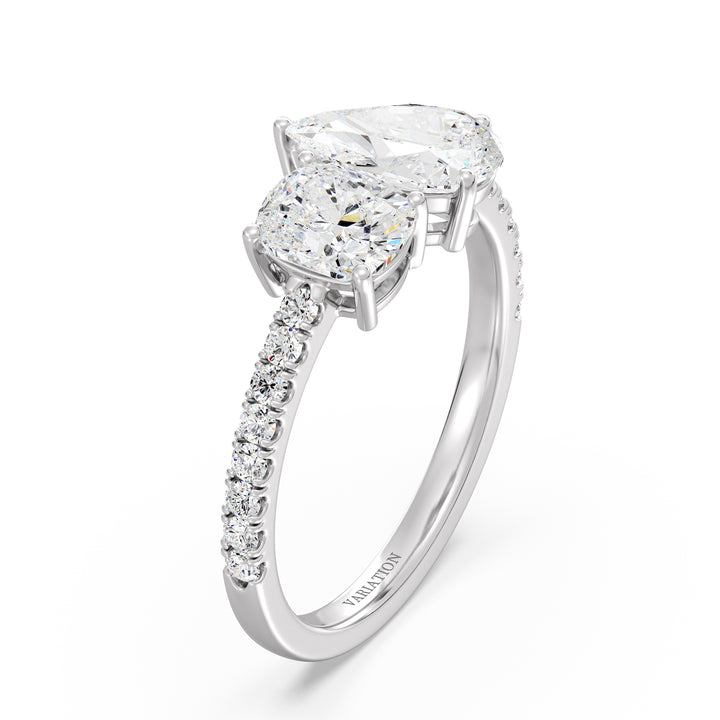 An elegant Pear & Cushion Two-Stone Lab-Grown Diamond 'Toi et Moi' Ring in 18K White Gold. Designed with a 1.00ct Pear-cut diamond and 1.00ct Cushion-cut diamond, set side by side in a classic prong setting. The sleek white gold band, adorned with 16 Round-Cut Lab-Grown Diamonds (0.24ct total), enhances the ring’s brilliance and sophistication.