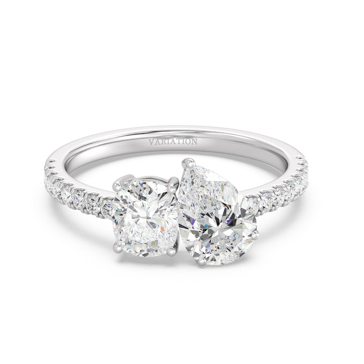 An elegant Pear & Cushion Two-Stone Lab-Grown Diamond 'Toi et Moi' Ring in 18K White Gold. Designed with a 1.00ct Pear-cut diamond and 1.00ct Cushion-cut diamond, set side by side in a classic prong setting. The sleek white gold band, adorned with 16 Round-Cut Lab-Grown Diamonds (0.24ct total), enhances the ring’s brilliance and sophistication.