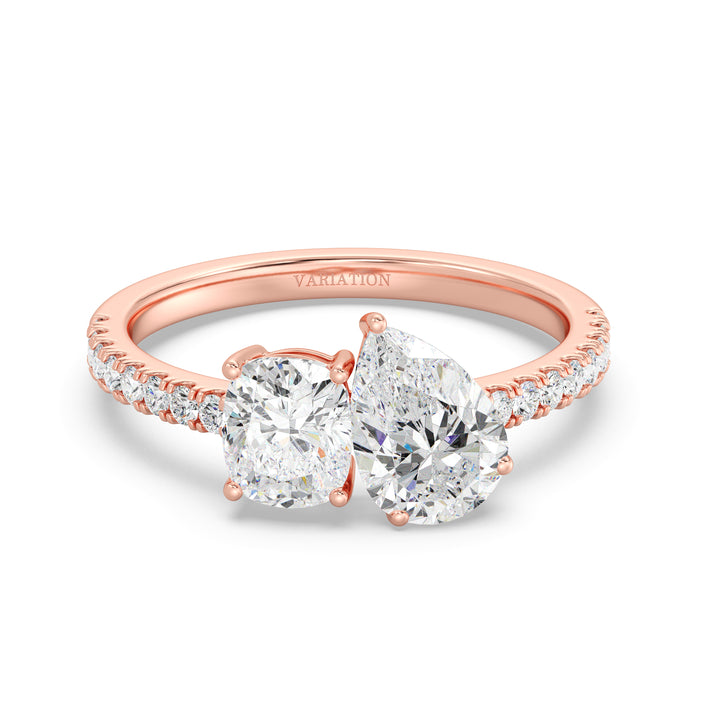 A romantic Pear & Cushion Two-Stone Lab-Grown Diamond 'Toi et Moi' Ring in 18K Rose Gold. Showcasing a 1.00ct Pear-cut diamond and 1.00ct Cushion-cut diamond, set in a delicate prong setting. The ring is further accentuated by 16 Round-Cut Lab-Grown Diamonds (0.24ct total) along the band. The soft blush tones of rose gold complement the brilliance of the diamonds, making it a perfect symbol of love and commitment.