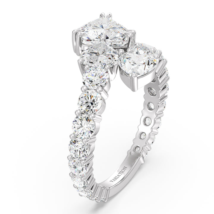 A sophisticated Three-Stone 'Toi et Moi' Heart-Shaped Lab-Grown Diamond Cluster Ring in 18K White Gold, featuring two 0.50ct EF/VS heart-cut lab-grown diamonds, a 1.00ct EF/VS heart-cut lab-grown diamond, and 18 round lab-grown diamonds, totaling 4.17ct. The cool-toned white gold band enhances the diamonds' brilliance, creating an elegant and modern look.