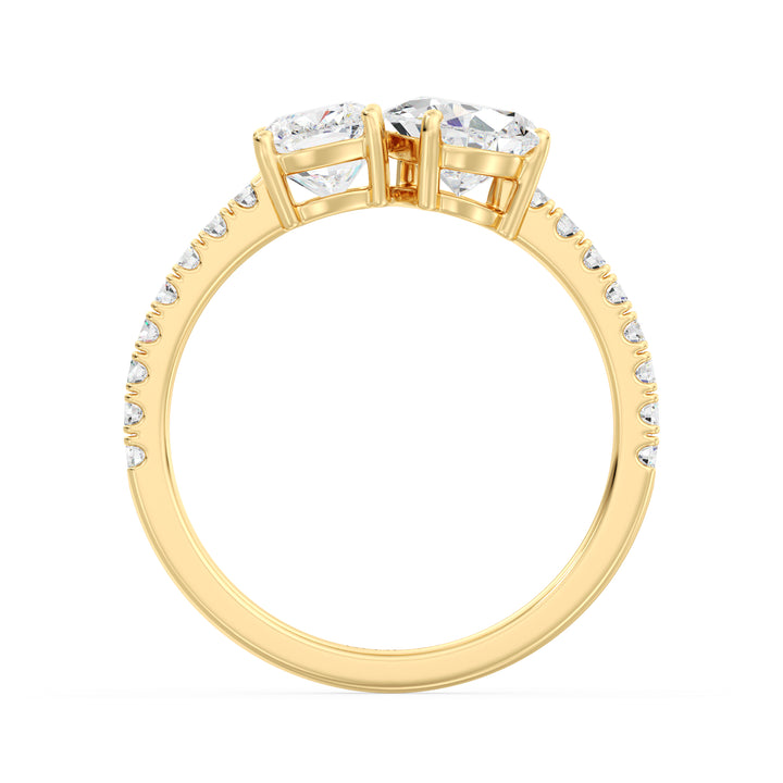 A stunning Pear & Cushion Two-Stone Lab-Grown Diamond 'Toi et Moi' Ring in 18K Yellow Gold. Featuring a 1.00ct Pear-cut diamond and 1.00ct Cushion-cut diamond, set side by side in a classic prong setting. The band is adorned with 16 Round-Cut Lab-Grown Diamonds (0.24ct total), adding extra sparkle. The warm yellow gold enhances the brilliance of the diamonds, creating a timeless and elegant look.