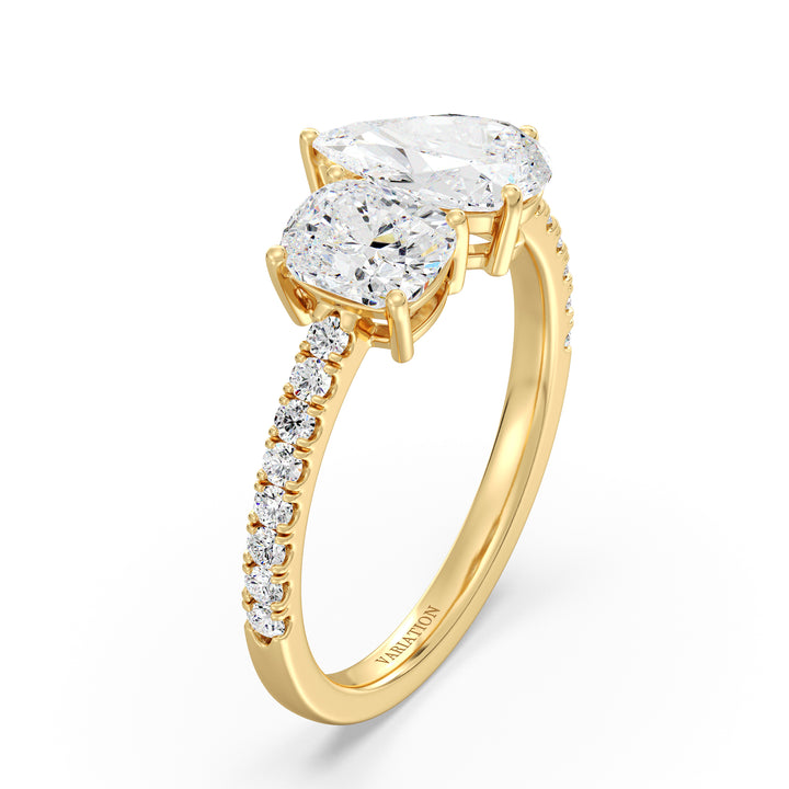 A stunning Pear & Cushion Two-Stone Lab-Grown Diamond 'Toi et Moi' Ring in 18K Yellow Gold. Featuring a 1.00ct Pear-cut diamond and 1.00ct Cushion-cut diamond, set side by side in a classic prong setting. The band is adorned with 16 Round-Cut Lab-Grown Diamonds (0.24ct total), adding extra sparkle. The warm yellow gold enhances the brilliance of the diamonds, creating a timeless and elegant look.