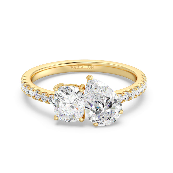 A stunning Pear & Cushion Two-Stone Lab-Grown Diamond 'Toi et Moi' Ring in 18K Yellow Gold. Featuring a 1.00ct Pear-cut diamond and 1.00ct Cushion-cut diamond, set side by side in a classic prong setting. The band is adorned with 16 Round-Cut Lab-Grown Diamonds (0.24ct total), adding extra sparkle. The warm yellow gold enhances the brilliance of the diamonds, creating a timeless and elegant look