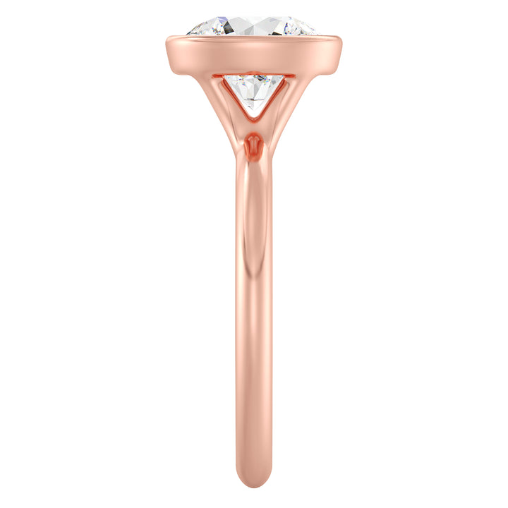 Elegant Round Cut Bezel Set Lab-Grown Diamond Solitaire Ring in 18K Rose Gold. Features a brilliant round cut diamond with a secure bezel setting