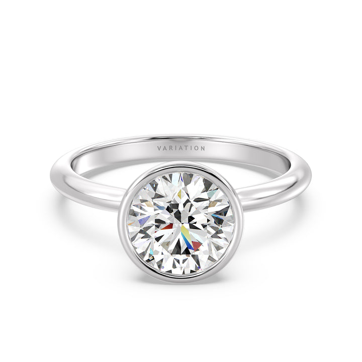 Elegant Round Cut Bezel Set Lab-Grown Diamond Solitaire Ring in 18K White Gold. Highlights a sparkling round cut diamond with a sophisticated bezel setting