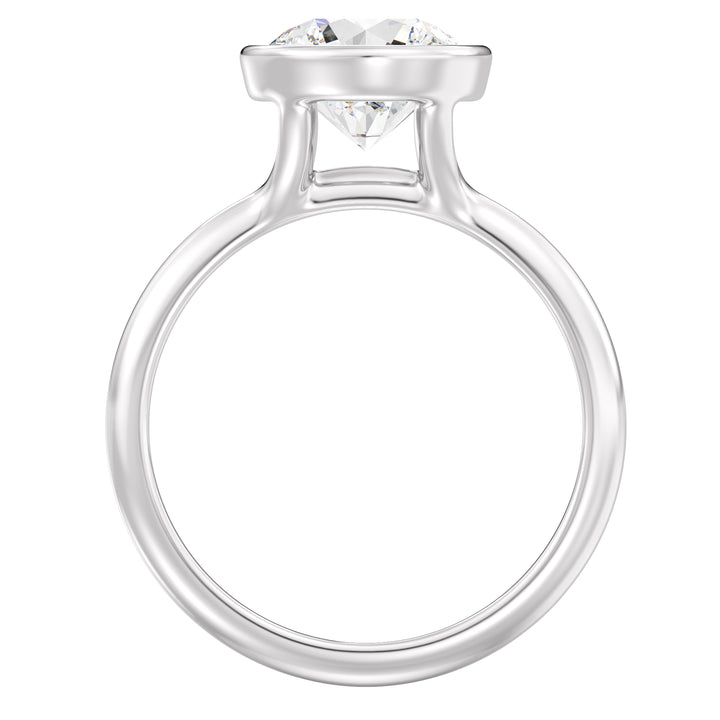 Elegant Round Cut Bezel Set Lab-Grown Diamond Solitaire Ring in 18K White Gold. Highlights a sparkling round cut diamond with a sophisticated bezel setting