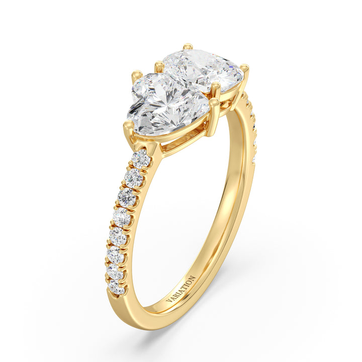 Heart & Cushion Two-Stone Lab-Grown Diamond 'Toi et Moi' Ring in 18K Yellow Gold. Featuring a 1.00ct heart-cut and a 1.00ct cushion-cut EF/VS lab-grown diamond in a classic prong setting, accented with 16 round-cut diamonds (0.24ct) on a sleek yellow gold band