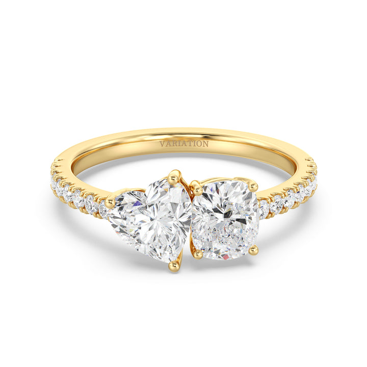 Heart & Cushion Two-Stone Lab-Grown Diamond 'Toi et Moi' Ring in 18K Yellow Gold. Featuring a 1.00ct heart-cut and a 1.00ct cushion-cut EF/VS lab-grown diamond in a classic prong setting, accented with 16 round-cut diamonds (0.24ct) on a sleek yellow gold band
