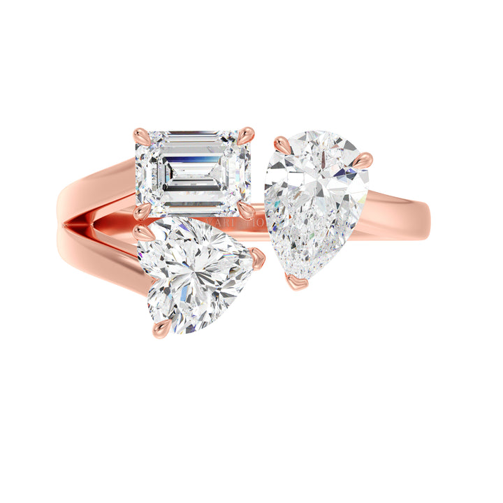 Three-Stone Toi et Moi Lab-Grown Diamond Ring in 18K Rose Gold, showcasing a 1.00ct Heart, 1.00ct Pear, and 1.00ct Emerald-cut EF/VS clarity diamonds in a classic prong setting. The romantic rose gold band beautifully contrasts with the diamonds, offering a modern yet vintage-inspired aesthetic