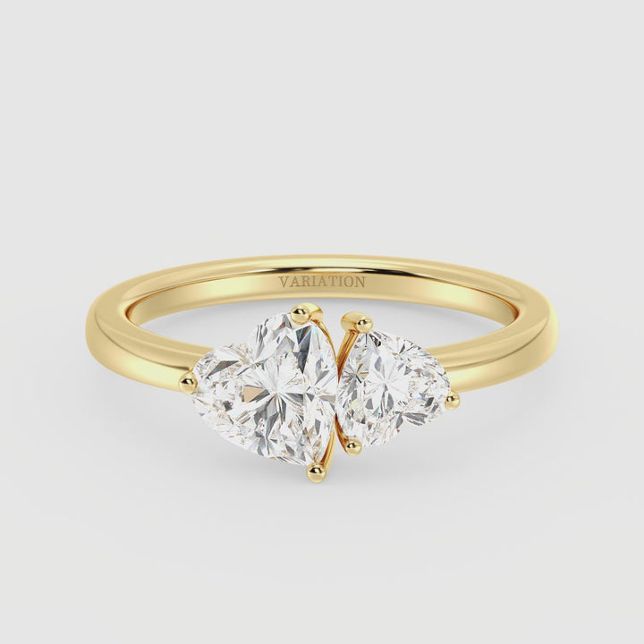18K Yellow Gold Toi et Moi Double Heart Diamond Engagement Ring featuring a 1.00ct and 0.50ct heart-cut lab-grown diamond in a classic prong setting. A romantic two-stone ring symbolizing love and unity, elegantly crafted in warm yellow gold