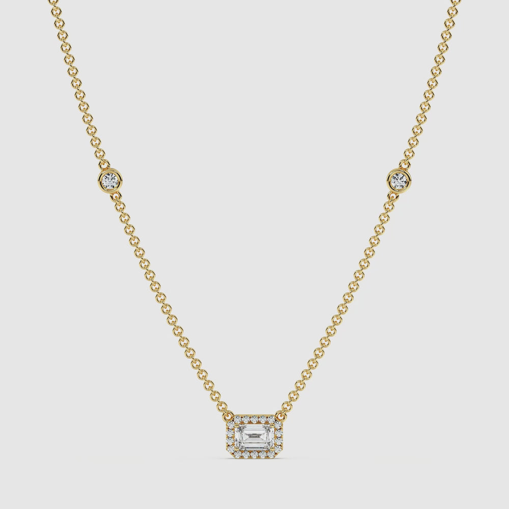 Video showcasing the Elegant Emerald Diamond Bezel Station Necklace in 18K Yellow Gold