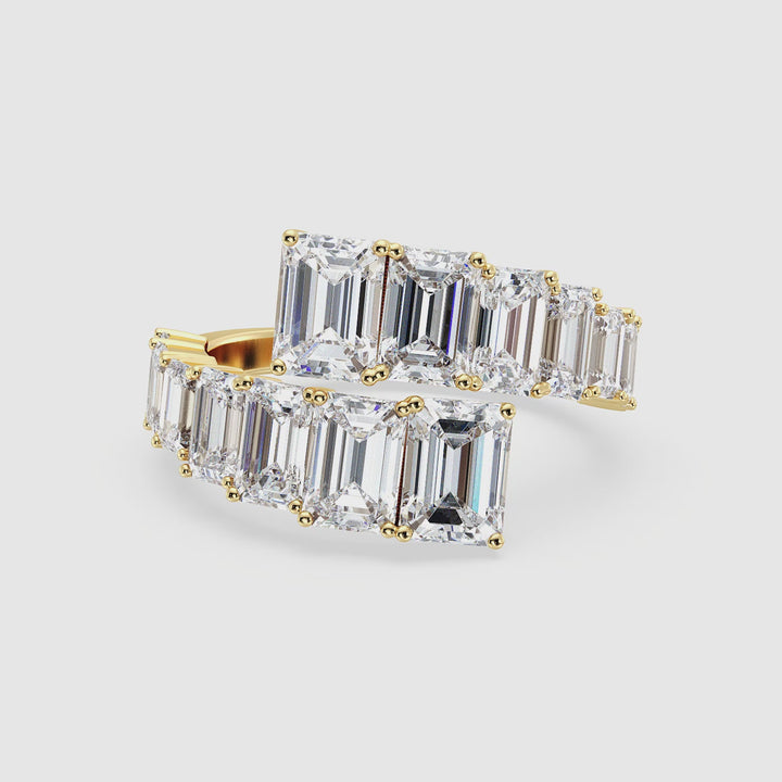 Rotating view of a 6 CTW Lab Grown Emerald-Cut Diamond Bypass Ring in 18K Yellow Gold, showcasing 14 prong-set EF/VS clarity diamonds in a graduated design, sparkling elegantly against a polished yellow gold band