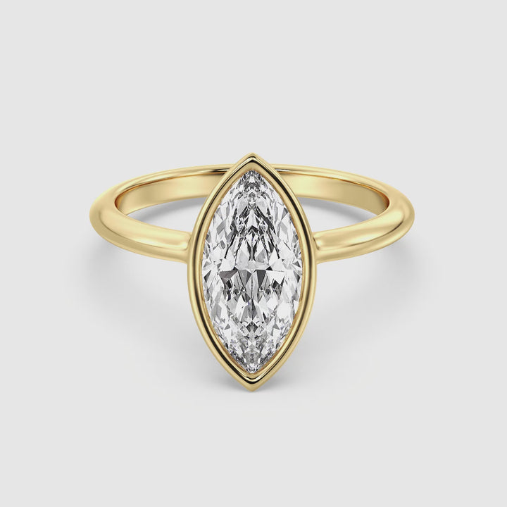 Video showcasing the Elegant Marquise Cut Bezel-Set Lab-Grown Diamond Solitaire Ring in 18K Yellow Gold. The video highlights the ring's exquisite 1ct, 2ct, 3ct, or 4ct marquise-cut diamond set in a sleek bezel setting, with close-ups of the intricate details and craftsmanship.