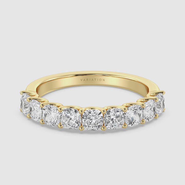 Video showing a 9-stone cushion-cut lab-grown diamond scallop half-eternity wedding ring in 18K yellow gold, highlighting the ring's elegant design with nine secure, low-profile prong-set diamonds. The video includes close-ups of the ring’s sparkle and craftsmanship, emphasizing its smooth finish and refined look