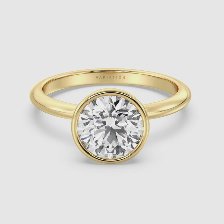 Video showcasing the Elegant Round Cut Bezel Set Lab-Grown Diamond Solitaire Ring in 18K Yellow Gold. The video highlights the ring's stunning round cut diamond, securely set in a sleek bezel design, with close-ups of the elegant yellow gold band and the diamond's brilliant sparkle