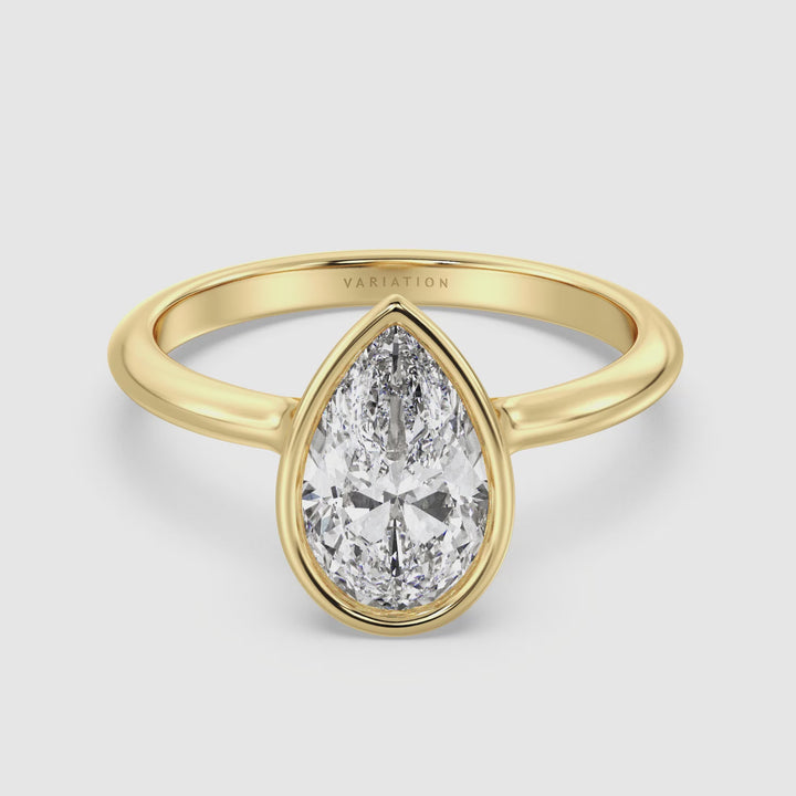 Video showcasing the Elegant Pear Cut Bezel Set Lab Grown Diamond Solitaire Ring in 18K yellow gold. The video highlights the pear-shaped lab-grown diamond, its brilliant EF color, and VS clarity, with a close-up view of the bezel setting. The ring is available in 1.00ct, 2.00ct, 3.00ct, or 4.00ct, demonstrating its timeless elegance and sophistication.