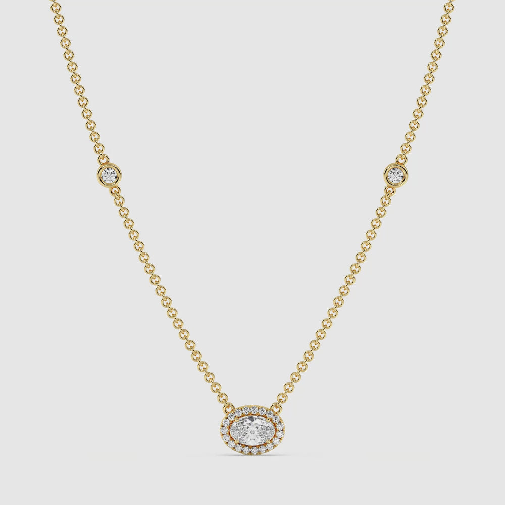 Video showcasing the Elegant Oval Diamond Bezel Station Necklace in 18K Yellow Gold