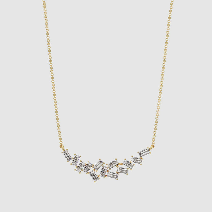 Close-up video of an elegant baguette lab-grown diamond cluster pendant necklace in 18K yellow gold, featuring 13 EF/VS baguette-cut diamonds totaling 0.65 carats, hand-set in a delicate cluster design, capturing light with every movement