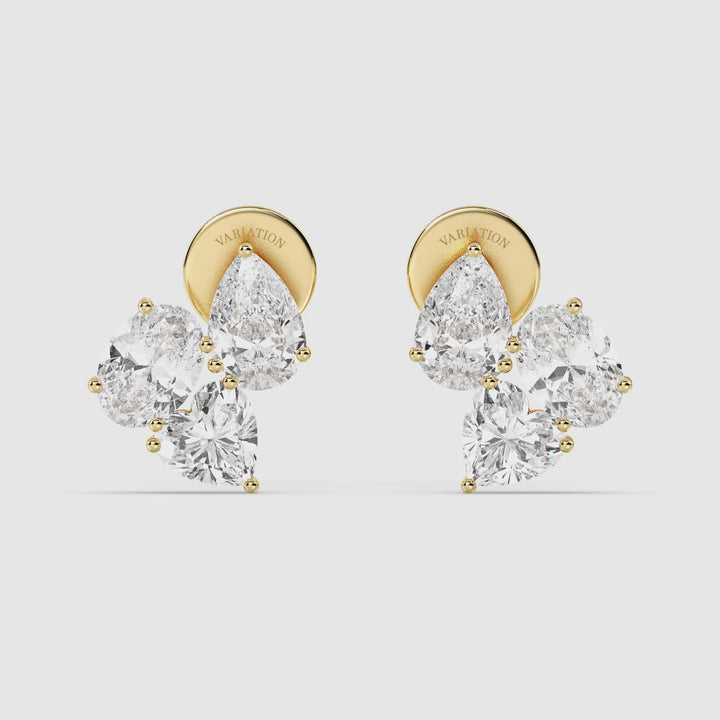 Close-up video of Nebula Flower Lab-Grown Diamond Stud Earrings in 18K Yellow Gold, showcasing a floral-inspired design with 1.50 carats of heart, pear, and oval-shaped EF/VS diamonds set in a modern gallery-style setting, reflecting brilliant sparkle and fine craftsmanship