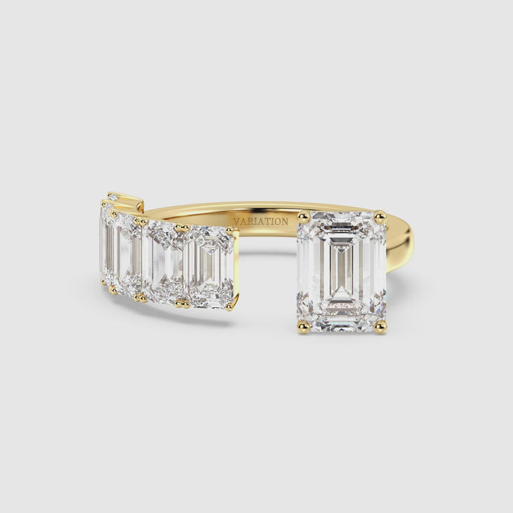 Close-up video of a Floating Emerald-Cut Lab-Grown Diamond Ring in 18K Yellow Gold, featuring a stunning 2.00ct emerald-cut center stone and five floating 0.50ct emerald-cut diamonds. The prong-set diamonds shimmer elegantly as the ring rotates, showcasing its brilliance, sleek band, and luxurious yellow gold finish. A timeless anniversary, engagement, or stackable promise ring with a modern Toi et Moi design.