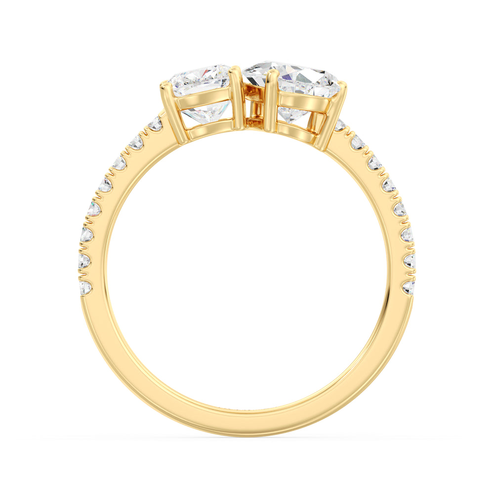 A stunning Pear & Cushion Two-Stone Lab-Grown Diamond 'Toi et Moi' Ring in 18K Yellow Gold. Featuring a 1.00ct Pear-cut diamond and 1.00ct Cushion-cut diamond, set side by side in a classic prong setting. The band is adorned with 16 Round-Cut Lab-Grown Diamonds (0.24ct total), adding extra sparkle. The warm yellow gold enhances the brilliance of the diamonds, creating a timeless and elegant look.