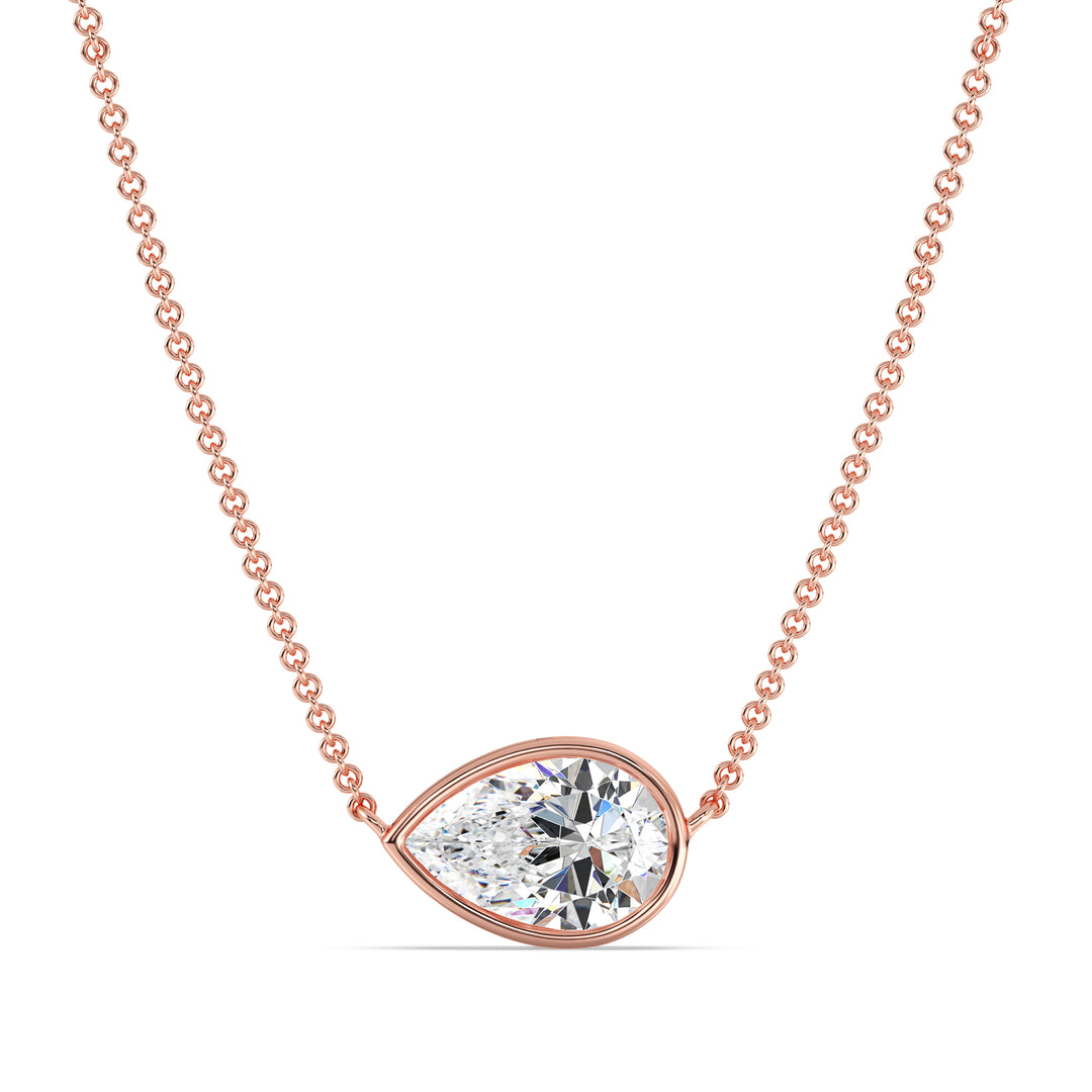 Close-up image of a 2 Carat Lab-Grown Pear-Cut Diamond Bezel-Set Solitaire Pendant Necklace in 18K Rose Gold, featuring a shimmering E/VS pear-cut diamond on a delicate rose gold chain