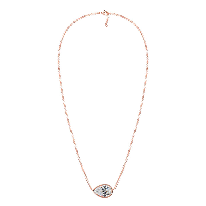 Close-up image of a 2 Carat Lab-Grown Pear-Cut Diamond Bezel-Set Solitaire Pendant Necklace in 18K Rose Gold, featuring a shimmering E/VS pear-cut diamond on a delicate rose gold chain