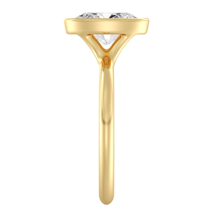 Timeless oval cut lab grown diamond bezel solitaire ring in 18K yellow gold offering elegant sparkle and everyday comfort.
