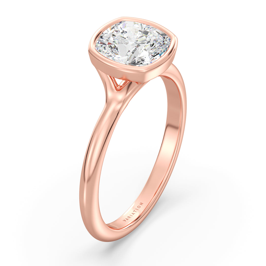 Cushion cut lab grown diamond bezel solitaire ring in 18K rose gold featuring an IGI certified diamond with a protective bezel setting and vintage-inspired charm.