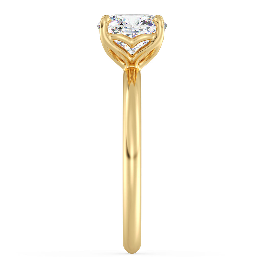 Cushion cut lab grown diamond ring in 18K yellow gold showcasing soft rounded corners and an open basket setting.