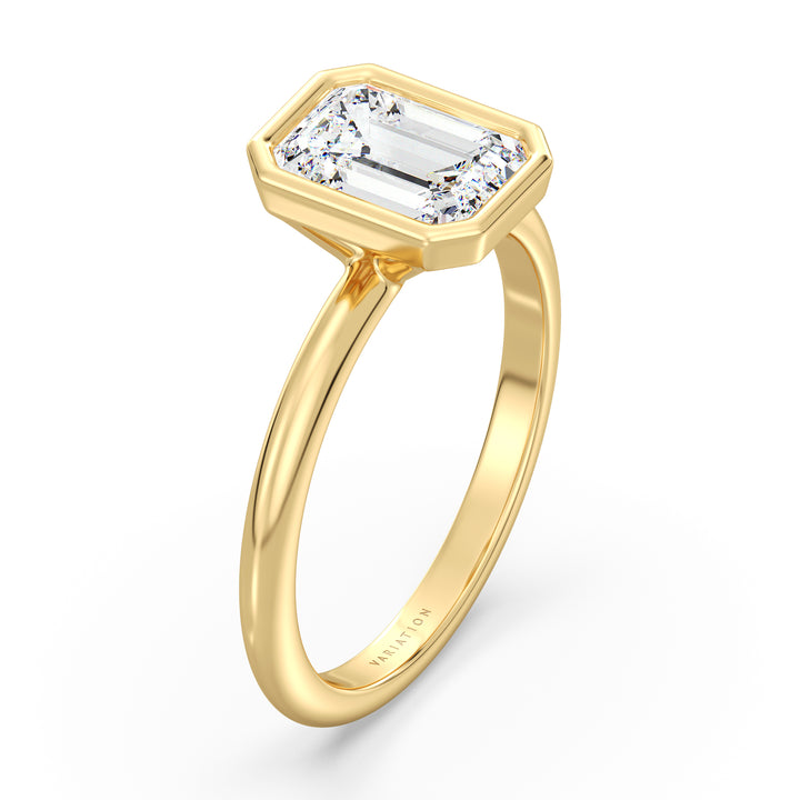 Side view of an emerald cut lab grown diamond bezel solitaire ring in 18K yellow gold highlighting clean geometric lines and a secure bezel setting.