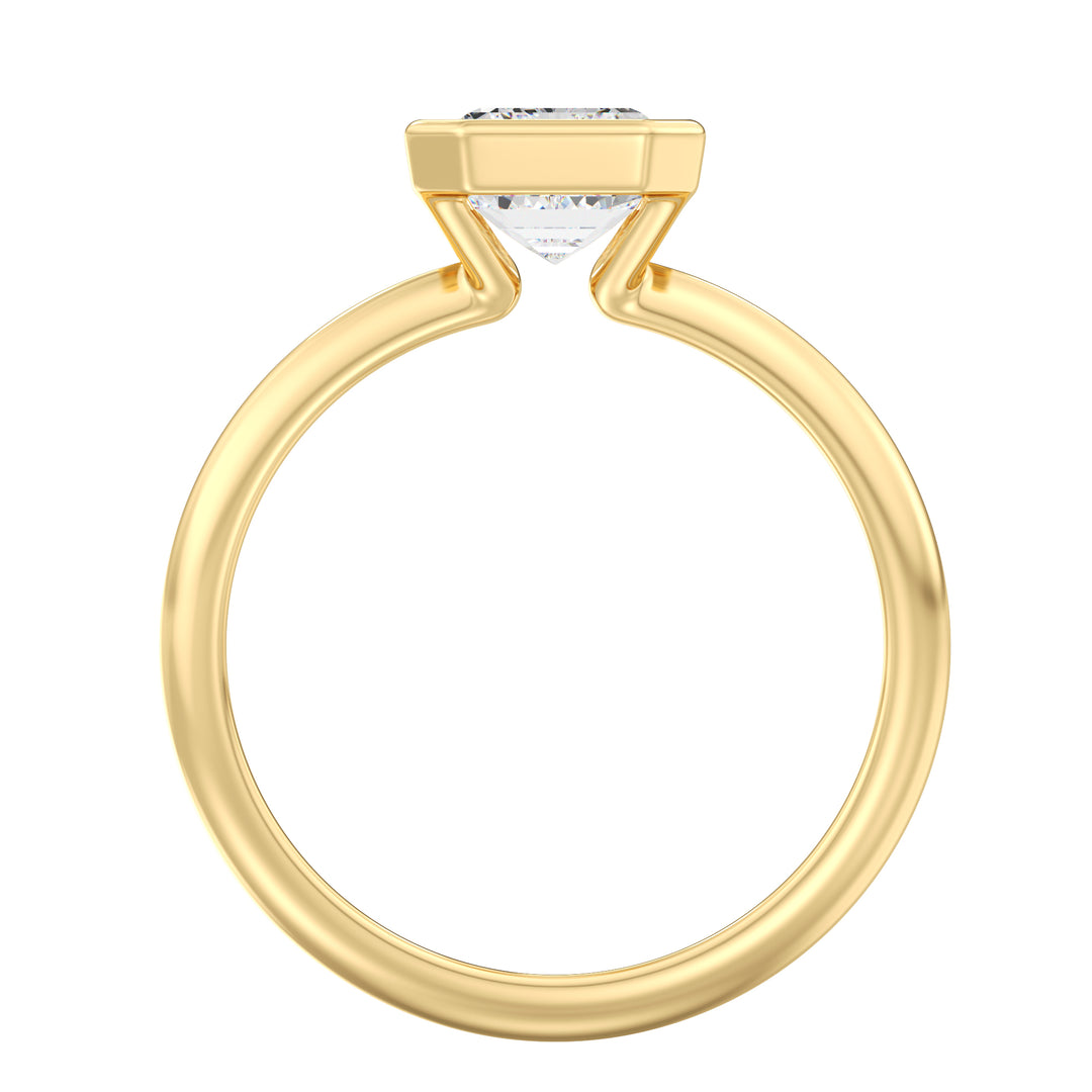 Top view of an emerald cut lab grown diamond bezel solitaire ring in 18K yellow gold showcasing exceptional clarity, step-cut facets, and modern elegance.