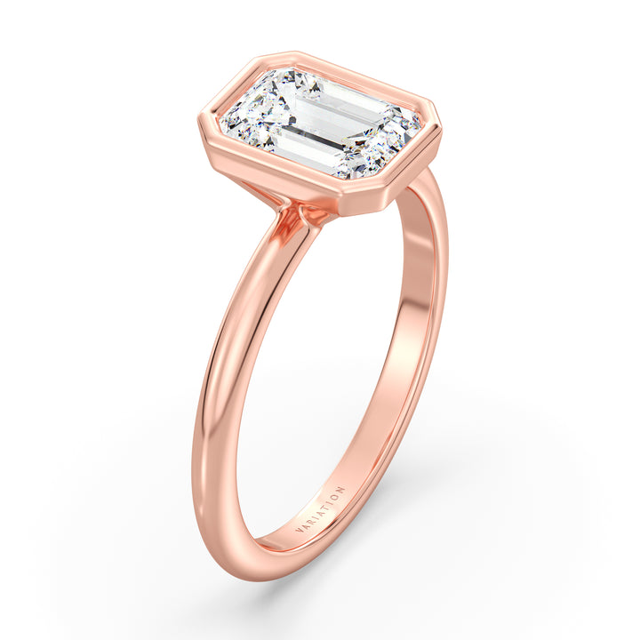 Emerald cut lab grown diamond bezel solitaire ring in 18K rose gold featuring an IGI certified diamond with a protective bezel setting and sophisticated style.