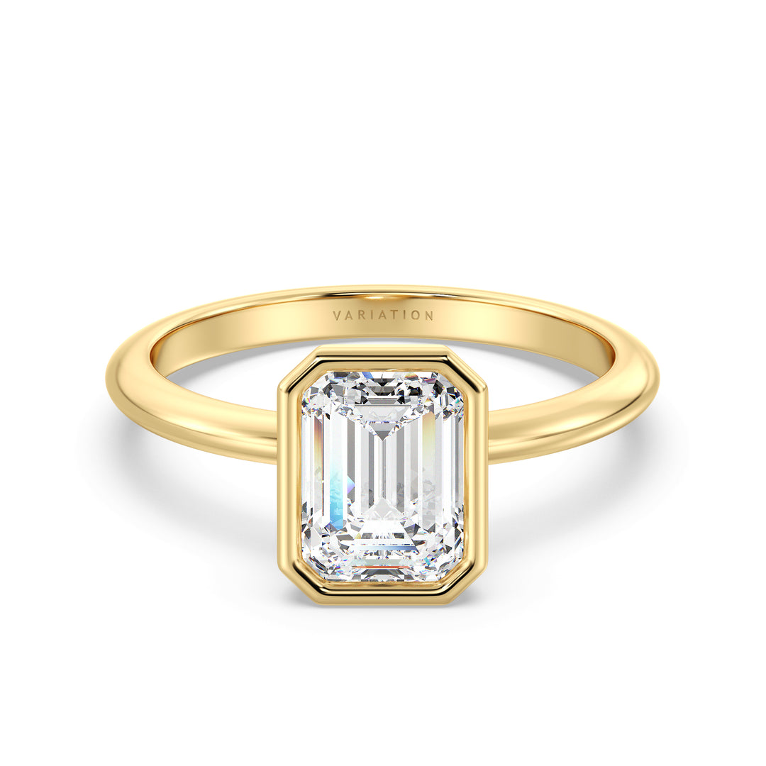 Emerald cut lab grown diamond bezel solitaire ring in 18K yellow gold featuring an IGI certified diamond with a modern bezel setting.