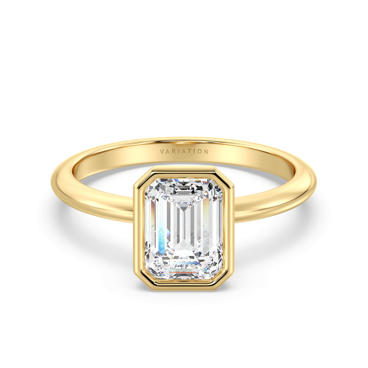 Emerald cut lab grown diamond bezel solitaire ring in 18K yellow gold featuring an IGI certified diamond with a modern bezel setting.