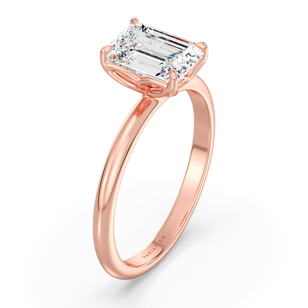 Emerald cut lab grown diamond solitaire ring in 18K rose gold featuring an IGI certified diamond with an elegant open basket setting.