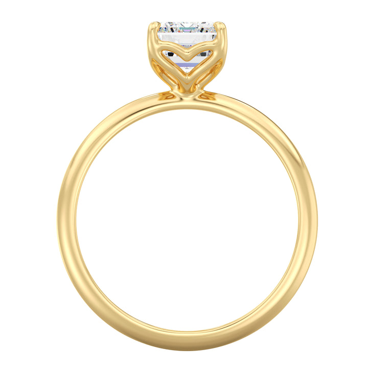 Emerald cut lab grown diamond ring in 18K yellow gold showcasing step-cut facets and an open basket setting.