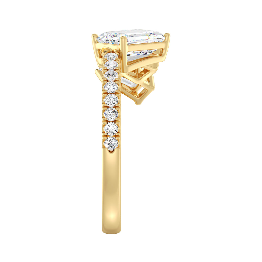 Graduated Emerald Cut Diamond Wedding Ring with Halo Accents in Yellow Gold