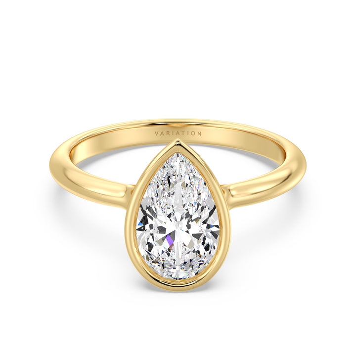 Elegant pear cut lab grown diamond bezel engagement ring crafted in 18K yellow gold with a sleek contemporary design.