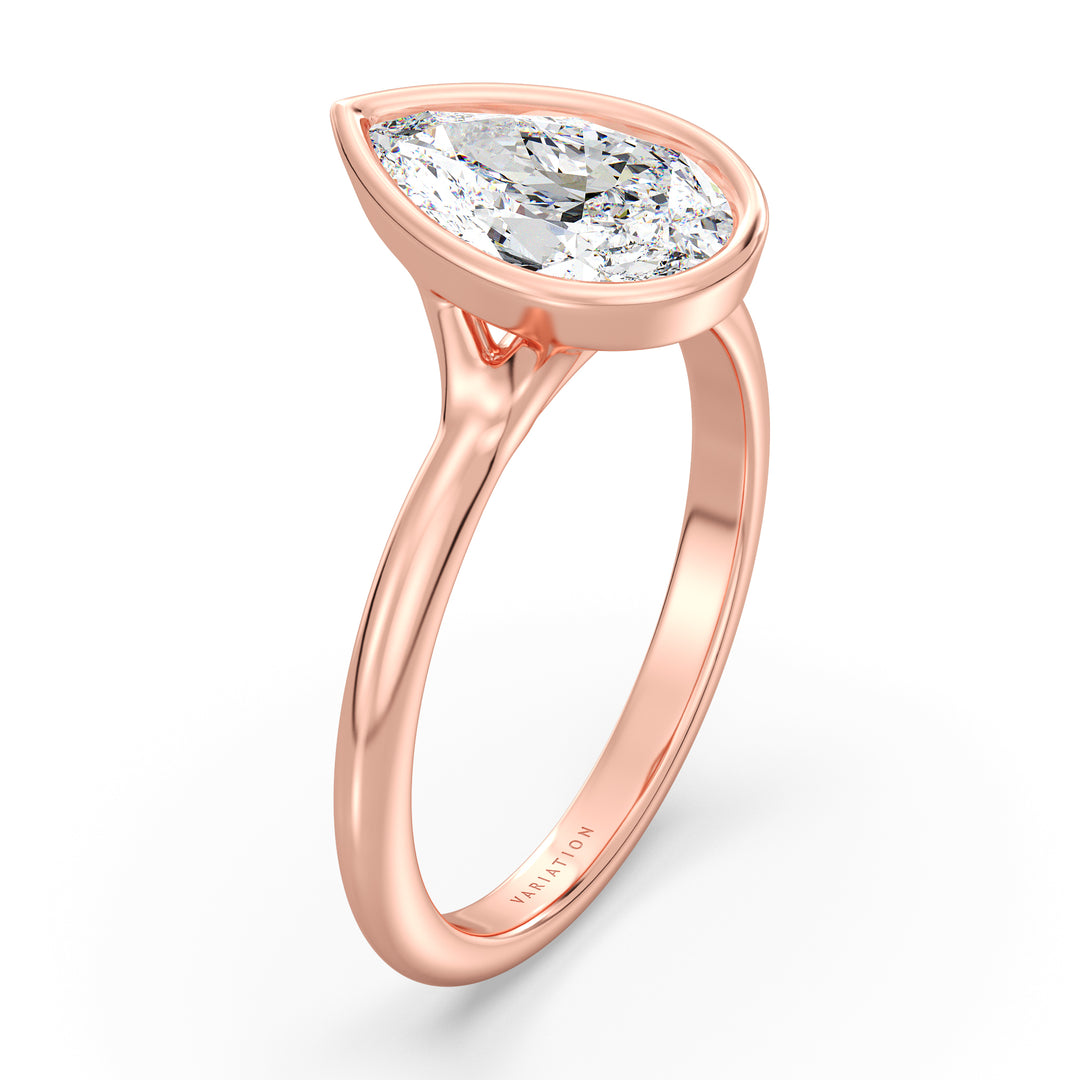 Pear cut lab grown diamond bezel solitaire ring in 18K rose gold featuring an IGI certified diamond with a protective bezel setting and romantic elegance.