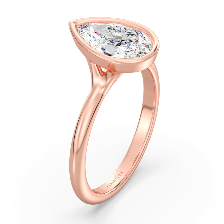 Pear cut lab grown diamond bezel solitaire ring in 18K rose gold featuring an IGI certified diamond with a protective bezel setting and romantic elegance.