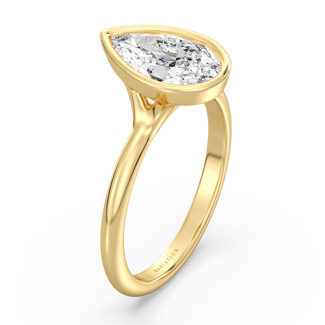 Pear cut lab grown diamond bezel solitaire ring in 18K yellow gold featuring an IGI certified diamond with a modern bezel setting.