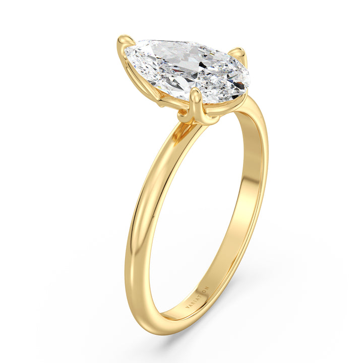 Pear cut lab grown diamond solitaire engagement ring in 18K yellow gold featuring an IGI certified diamond in an open basket setting with claw prongs.