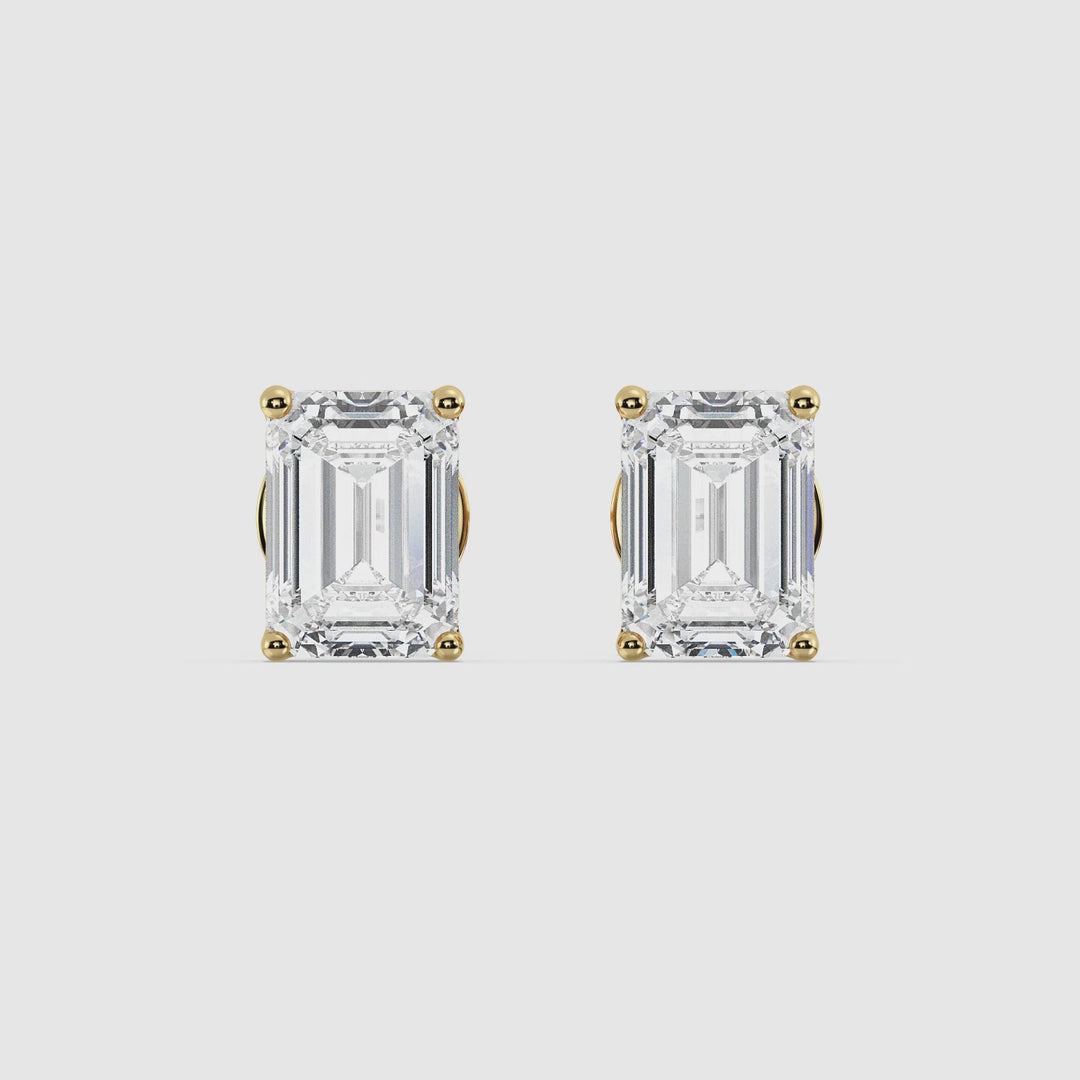 Video showcasing Exquisite Emerald Cut Lab-Grown Diamond Stud Earrings in Yellow Gold. Featuring close-up views of the dazzling EF/VS lab-grown diamonds set in luxurious 18K yellow gold. Perfect for any occasion, highlighting their stylish design and brilliant sparkle.