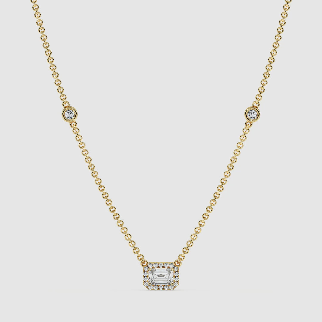 Video showcasing the Elegant Emerald Diamond Bezel Station Necklace in 18K Yellow Gold